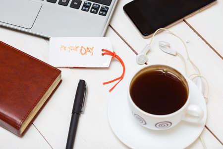 laptop and a cup of coffee, headphones, notebook, phoneの写真素材