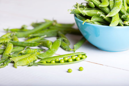 Fresh green peas on a wooden table