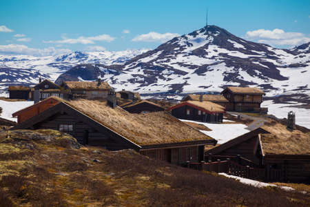 old traditional norwegian wooden house in Tyin and mountains in the background, Norwaynの写真素材