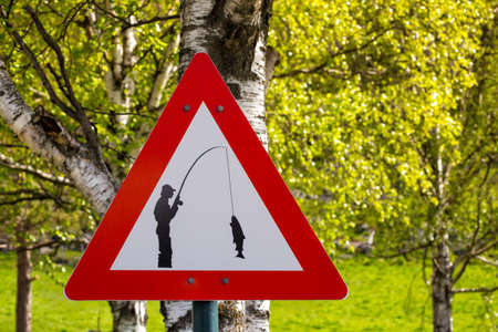 road sign - carefully fisherman catches a fish, norwayの写真素材