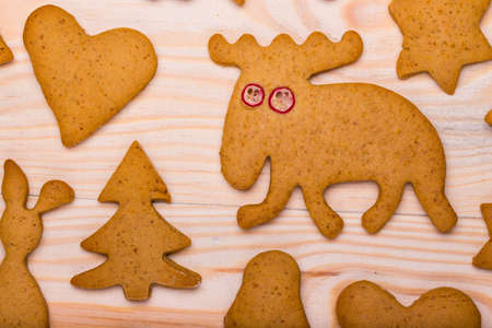 background with christmas gingerbread cookies on a wooden tableの写真素材