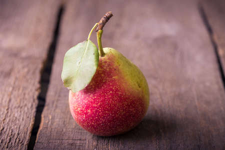 pears lying on an old obsolete wooden tableの写真素材