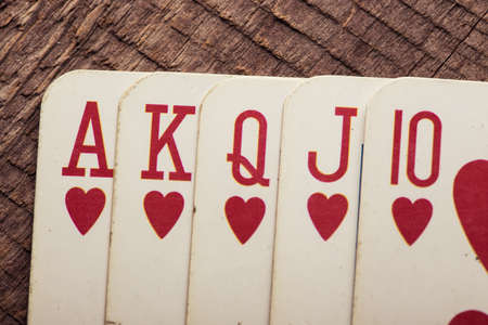 flush royal combination cards lying on a wooden tableの写真素材