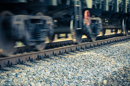 blurred motion of spinning train wheels close upの写真素材