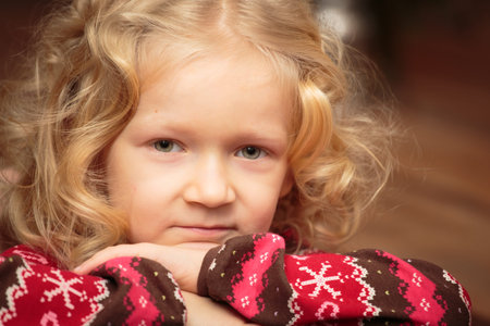 portrait of smiling curly little girl indoors