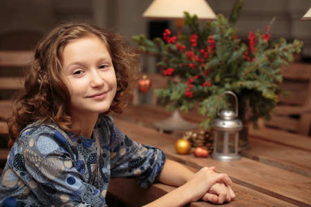 portrait of smiling curly little girl indoorsの写真素材
