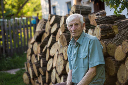 senior man sitting near his rural houseの写真素材