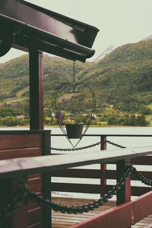 traditional norwegian wooden house and mountains in the distance, norwayの写真素材