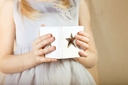 Christmas decor, Girl holding a Christmas candleの写真素材