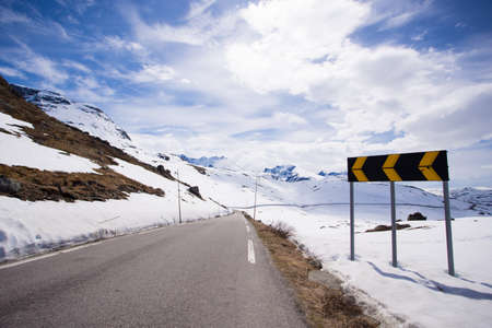 road sign on a snowy mountain road at the Norwayの写真素材