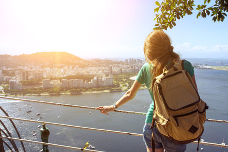 girl tourist with a backpack on the background Rio de Janeiro. view from Pao de Acucar