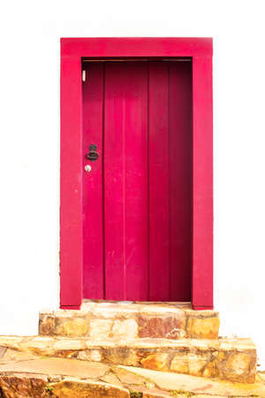 bright red wooden door in the historic town, Tiradentes, Brazilの写真素材