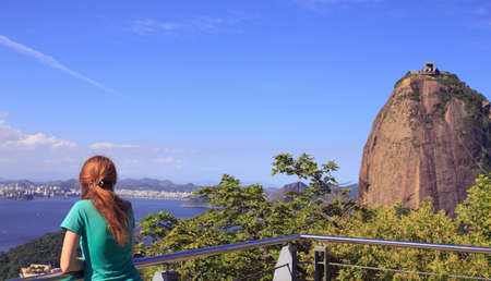 girl tourist on Pao de Acucar looking  at the Rio de Janeiroの写真素材
