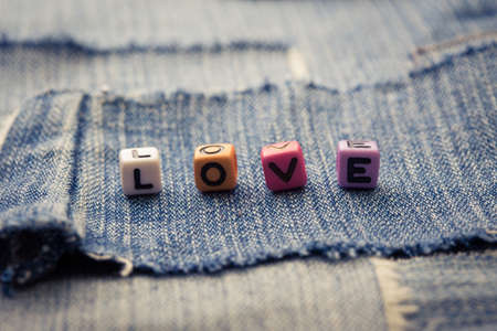 cubes with letters love on a jeans backgroundの写真素材
