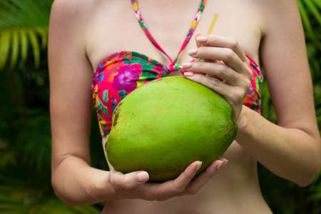 woman hands with the green coconut close upの写真素材