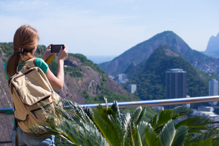 girl tourist  looks at Rio landscape from the Pao do Asucar viewpoint