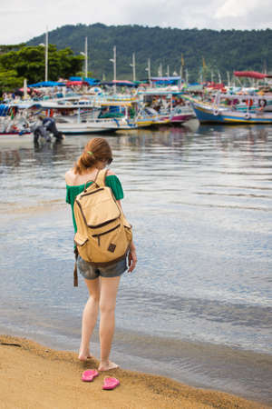 girl tourist walking on a beach at Paraty Brazilの写真素材