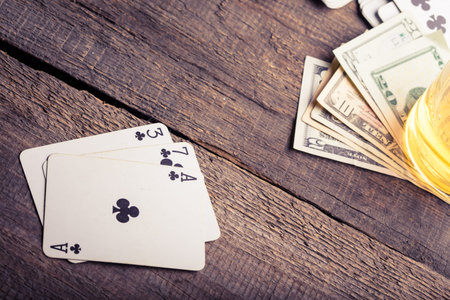 three, seven, ace playing card combination on a wooden table