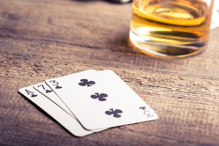 three, seven, ace playing card combination on a wooden table