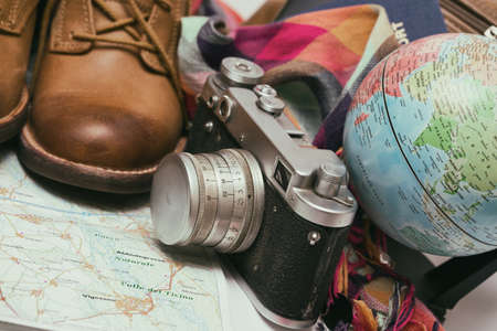 background - what to take for a trip. passport, phone, documents, map, camera, globe, handbag, boots, accessoriesの写真素材