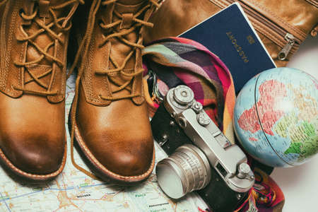 background - what to take for a trip. passport, phone, documents, map, camera, globe, handbag, boots, accessoriesの写真素材