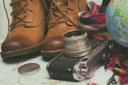 background - what to take for a trip. passport, phone, documents, map, camera, globe, handbag, boots, accessoriesの写真素材