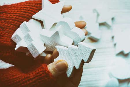 Christmas Background - female hands in red gloves hold a New Year's toysの写真素材