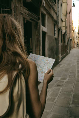 traveler girl looks at the map of walking in Venice, Italyの写真素材