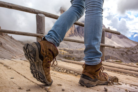 hiking boots close-up. tourist walking on the trail. Italy