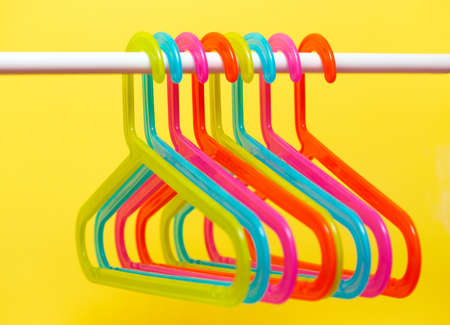 multicolored hangers on white background with small depth of fieldの写真素材