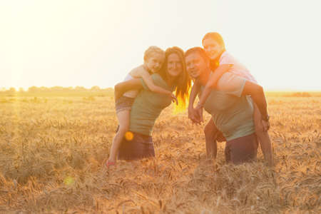 family with daughters outdoors at the field, Ukraineの写真素材