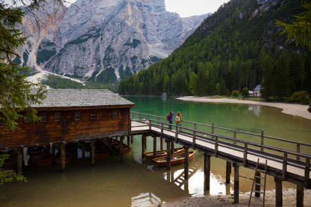 girls backpacker standing on a pier and looking at Braies lake, Dolomites Italy
の写真素材