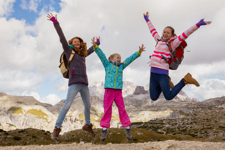 family - mother and two daughters  girls sisters hikers at the mountains Dolomites, Italy. Tre Cime di Lavaredoの写真素材