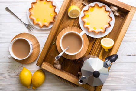 Breakfast - a tray of lemon tarts and coffee
の写真素材