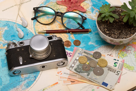 Plan of trip. background - what to take for a trip. map, retro camera, money, sunglasses, coins,...