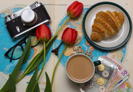 Plan of trip. background - what to take for a trip. map, retro camera, money, coins, croissant,...