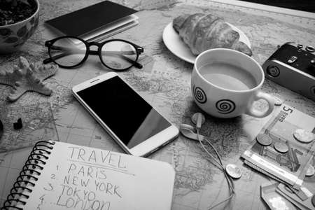 Plan of trip. map, retro camera, money, sunglasses, notepad for writing ideas, coins, headphones, smartphone,の写真素材