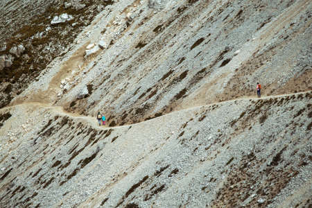 Mom and daughter are on the trail and view of  Tre Cime di Lavaredo. Dolomites, Italy.の写真素材