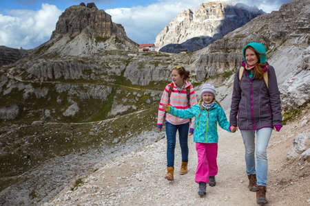 family - mother and two daughters  girls sisters hikers at the mountains Dolomites, Italy. Tre Cime di Lavaredoの写真素材