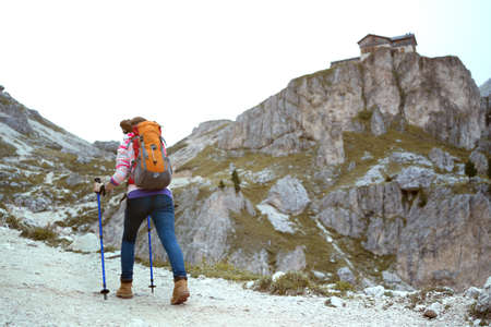 girl hiker at the mountains Dolomites, view of the  Rifugio Vajolet, Pozza Di Fassa, Italyの写真素材