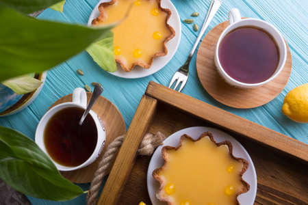 Breakfast - a tray of lemon tarts and coffeeの写真素材