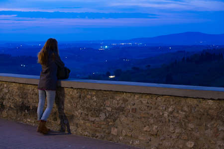 girl looking at the night valley Val d Orciaの写真素材