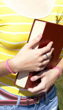 girl reading a book at the outdoors