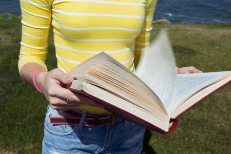 girl reading a book at the outdoorsの写真素材