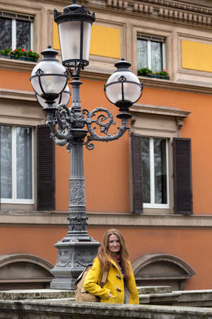 happy girl standing near parapet and looking at the camera, Bologna. italyの写真素材