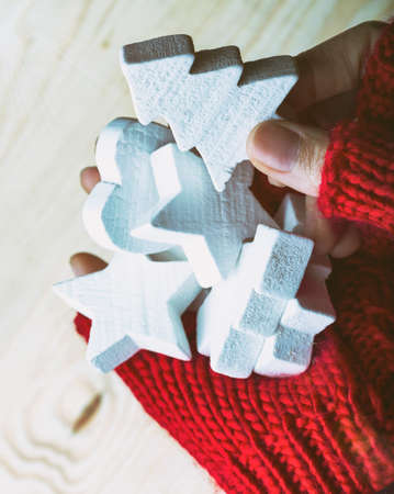 Christmas Background - female hands in red gloves hold a New Year's toysの写真素材