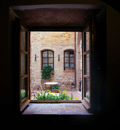 View of the Italian courtyard through the window,  italyの写真素材