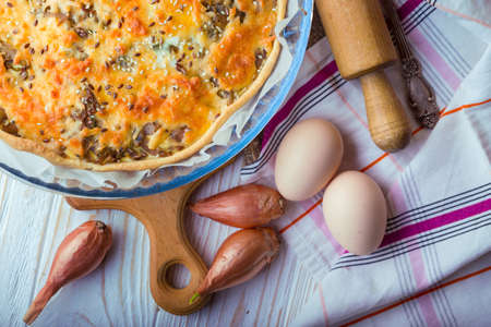 French onion pie on a plate, near fork, eggs, onionの写真素材
