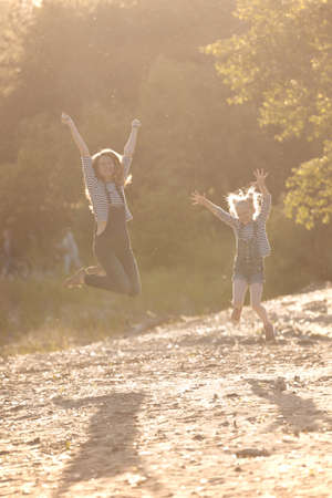 happy family -  Mother and daughter on a walk in the sunsetの写真素材