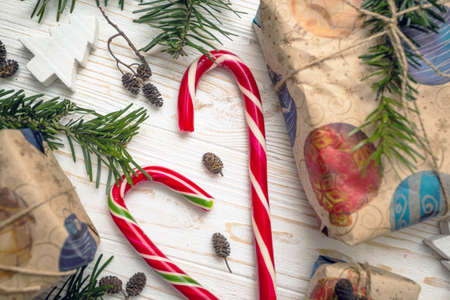 Christmas backgrounds. Gifts and candy caner on the wooden background.の写真素材